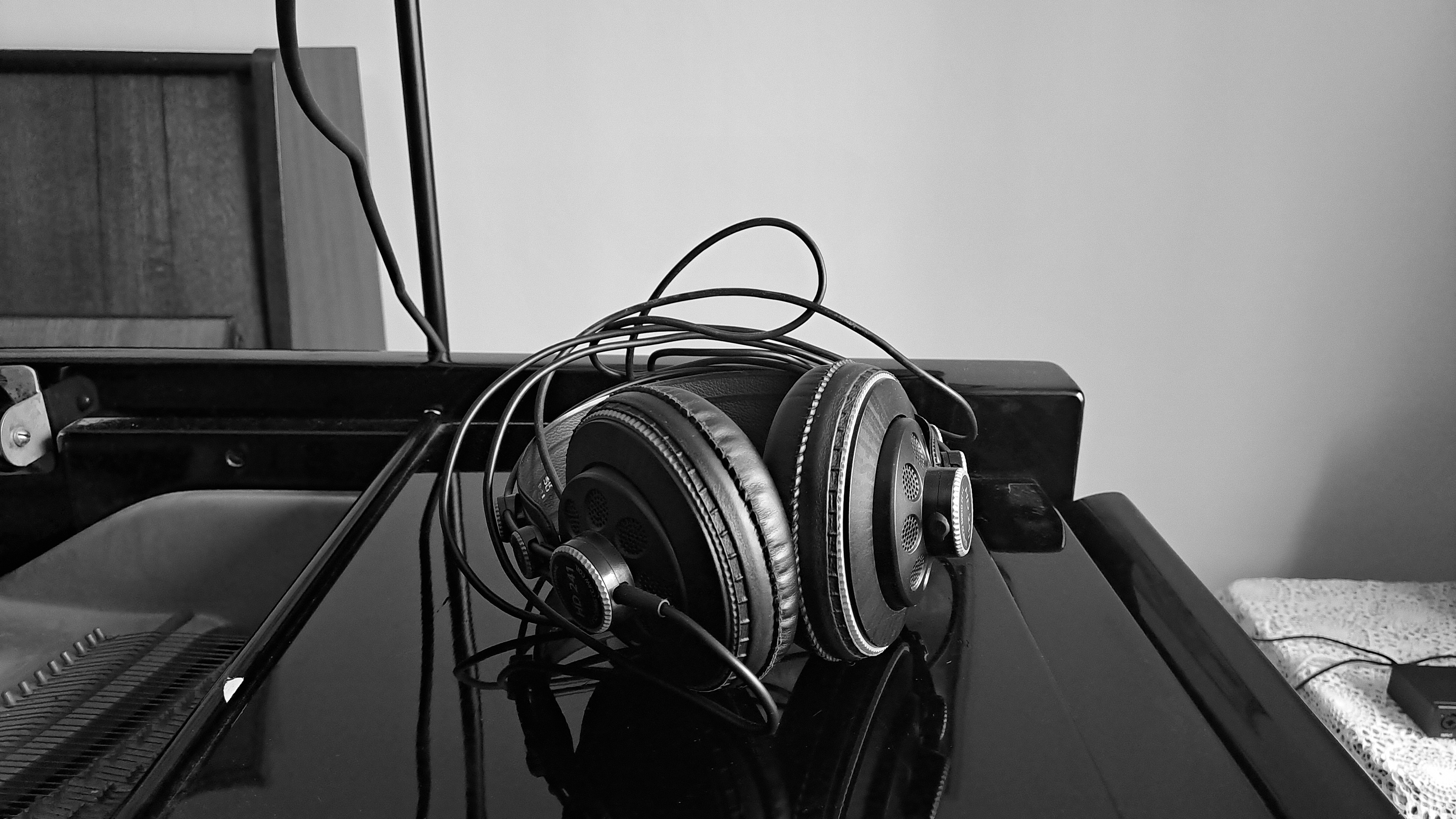Professional studio headphones on the lid of a grand piano